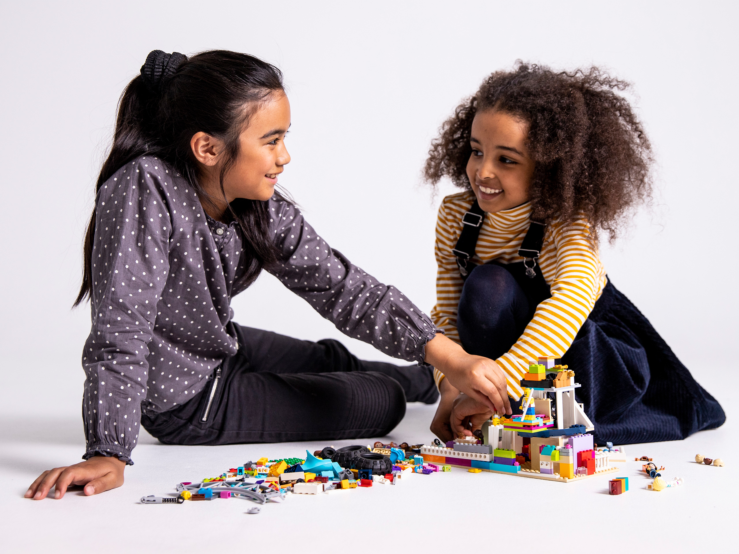Image of two girls playing with LEGO bricks
