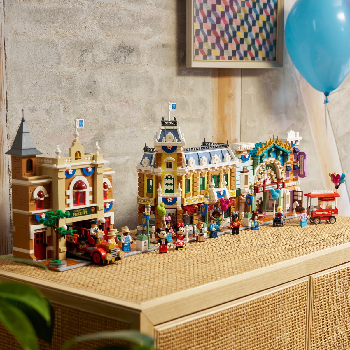 LEGO Disney Main Street, U.S.A. set arranged on a shelf with buildings and figures