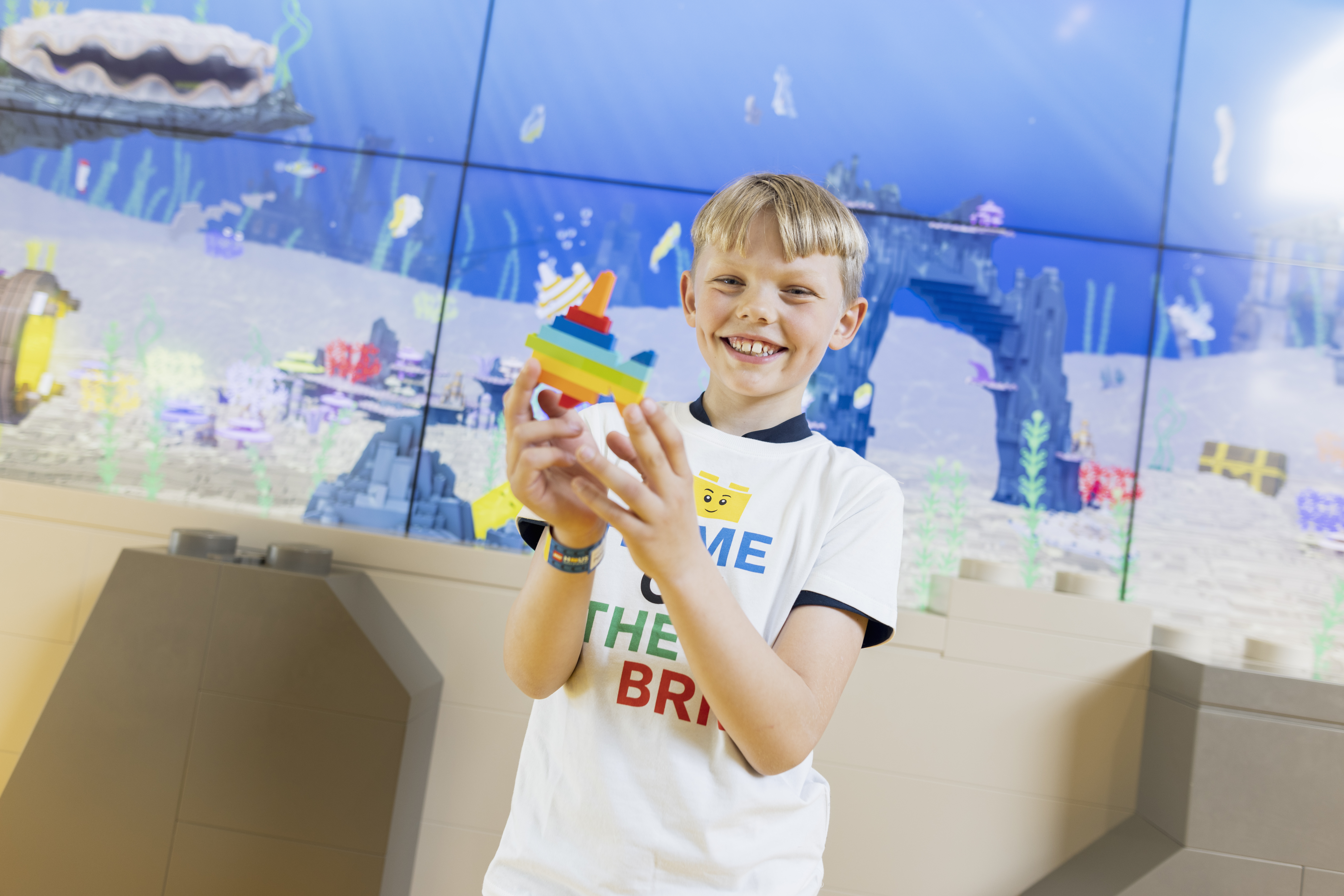 image of a kid in LEGO House YELLOW Zone Fish Designer area