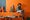 Lifestyle image of a boy in his orange room beside the LEGO® NINJAGO® City Gardens set