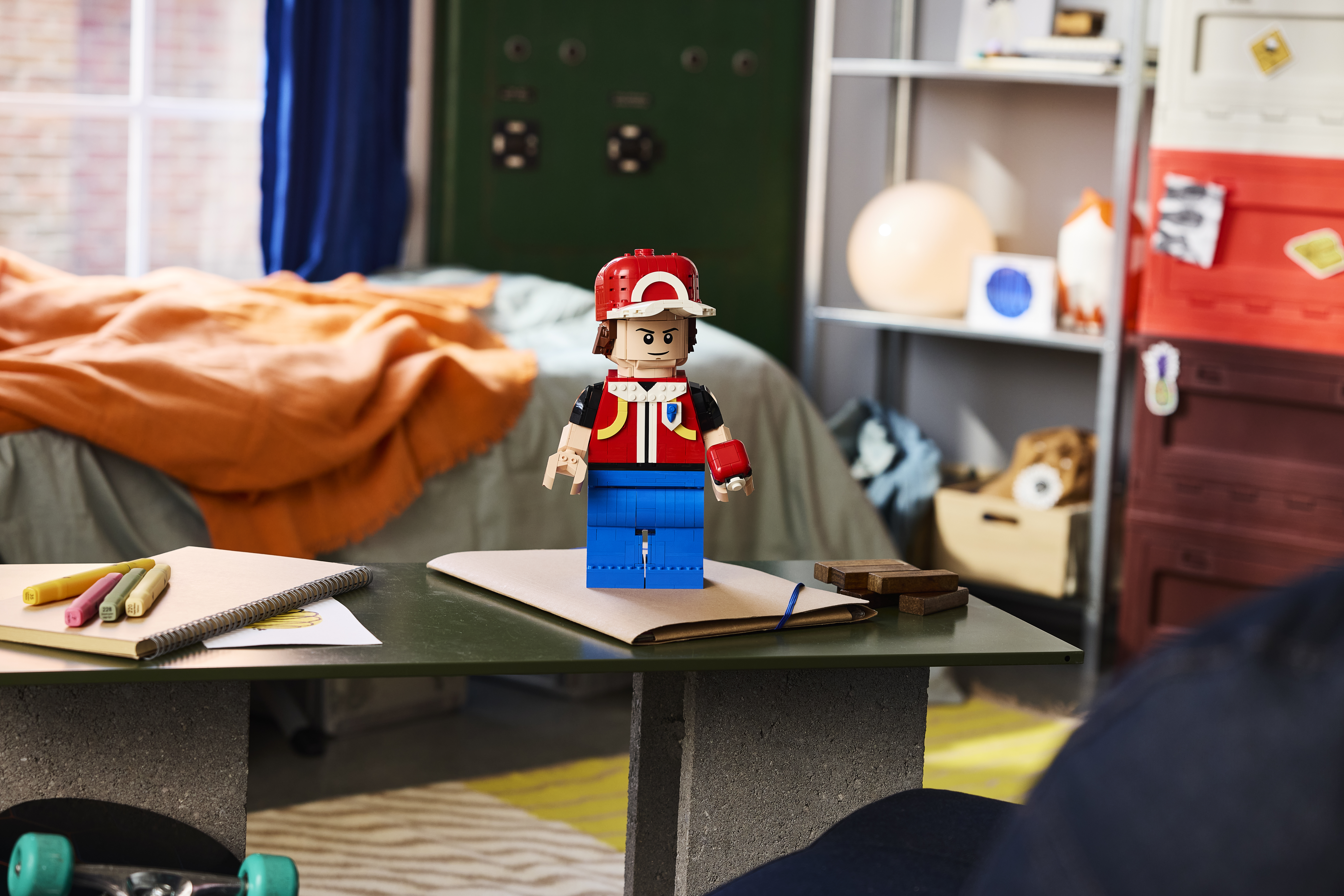LEGO Pokémon Up-Scaled Red Minifigure 40868 lifestyle image, the first-ever LEGO Pokémon Trainer minifigure