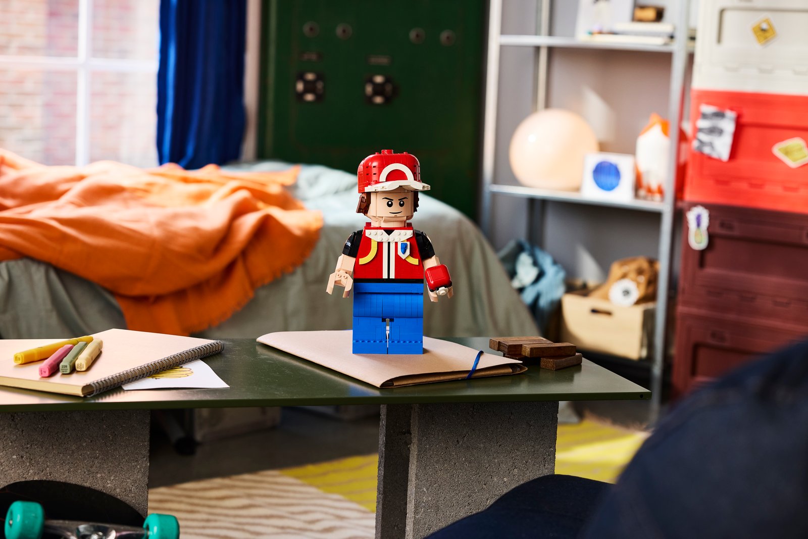 LEGO Pokémon Up-Scaled Red Minifigure 40868 lifestyle image, the first-ever LEGO Pokémon Trainer minifigure