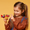 Lifestyle image of a girl holding the LEGO® Disney Mickey and Friends Mickey Mouse’s Propeller Plane