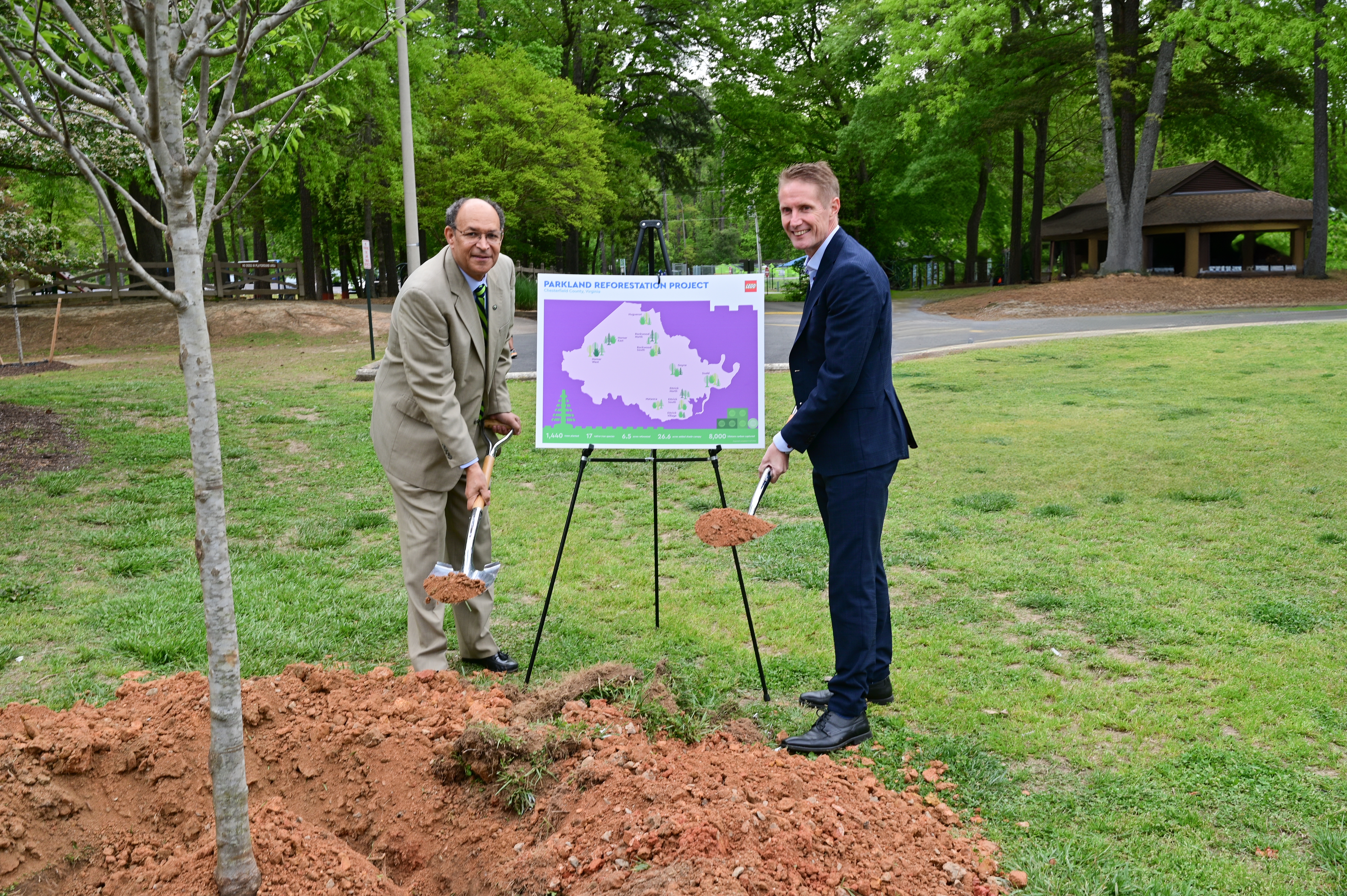 The LEGO Group’s Preben Elnef and James M. “Jim” Holland, Chair, Chesterfield County Board of Supervisors, plant a tree in Rockwood Park as a ceremonial marker of the public-private reforestation program.