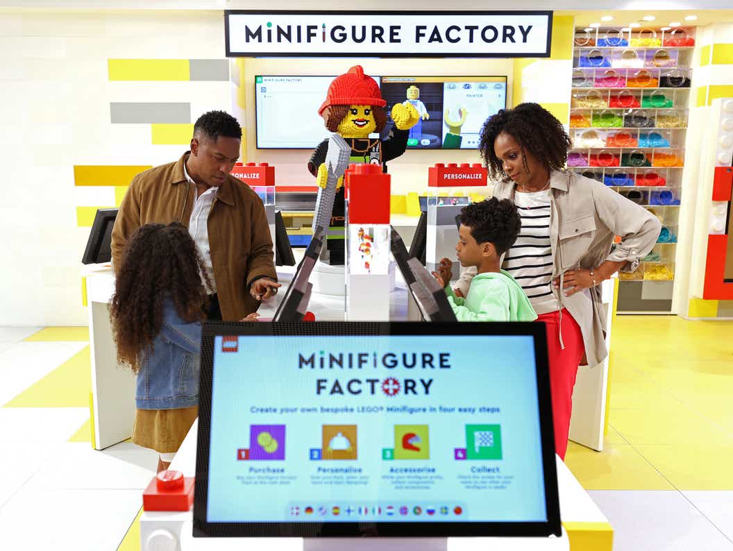 Lifestyle image of family trying out the Minifigure Factory