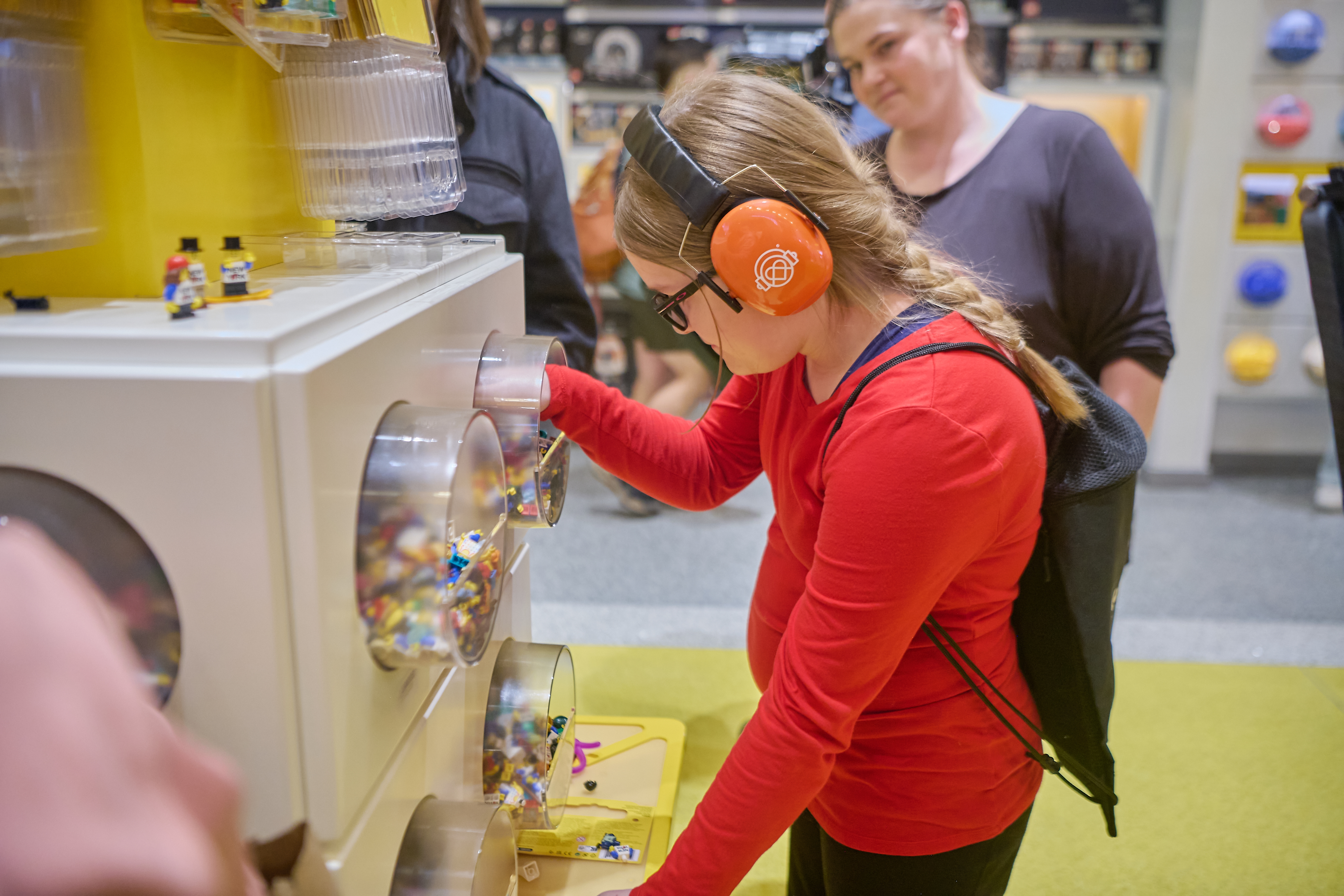 samantha, mom to Isabella who is 11 and autistic at the LEGO store flatiron in US trying out the Kulture City sensory bags