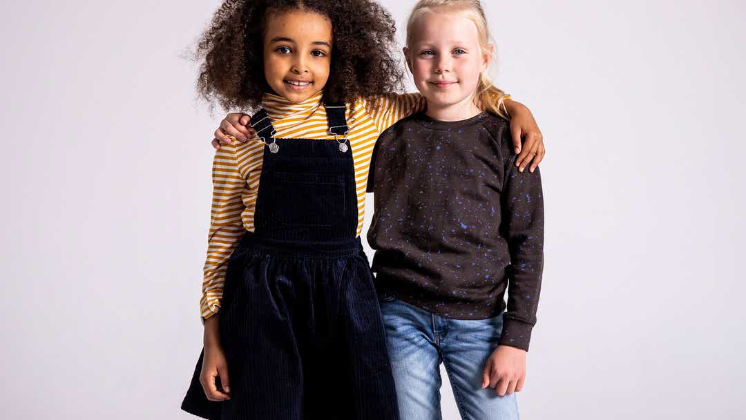 Image of two girls with their arms around one another