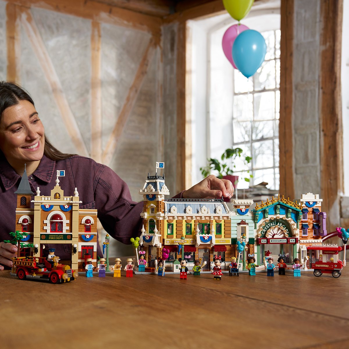 LEGO Disney Main Street, U.S.A. set displayed with buildings, figures, and balloons