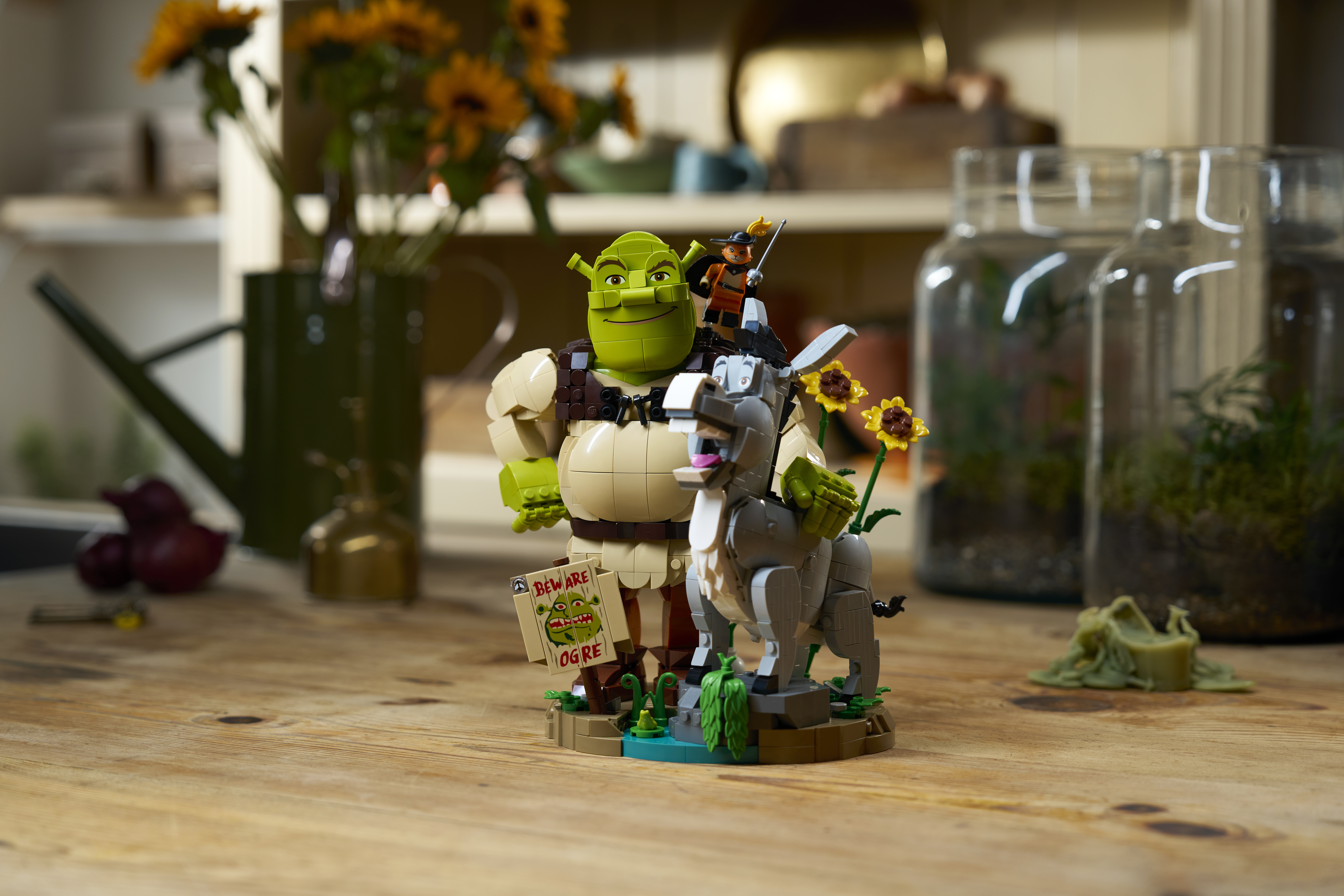 LEGO Shrek 72423 environmental lifestyle shot showing Shrek, Donkey and Puss in Boots brick-built characters in swamp setting