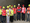 A group of LEGO colleagues in hi-viz vests and building hats