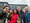 A group shot of a family standing smiling outside LEGO Campus