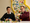 Two males sat down at a table playing with LEGO bricks