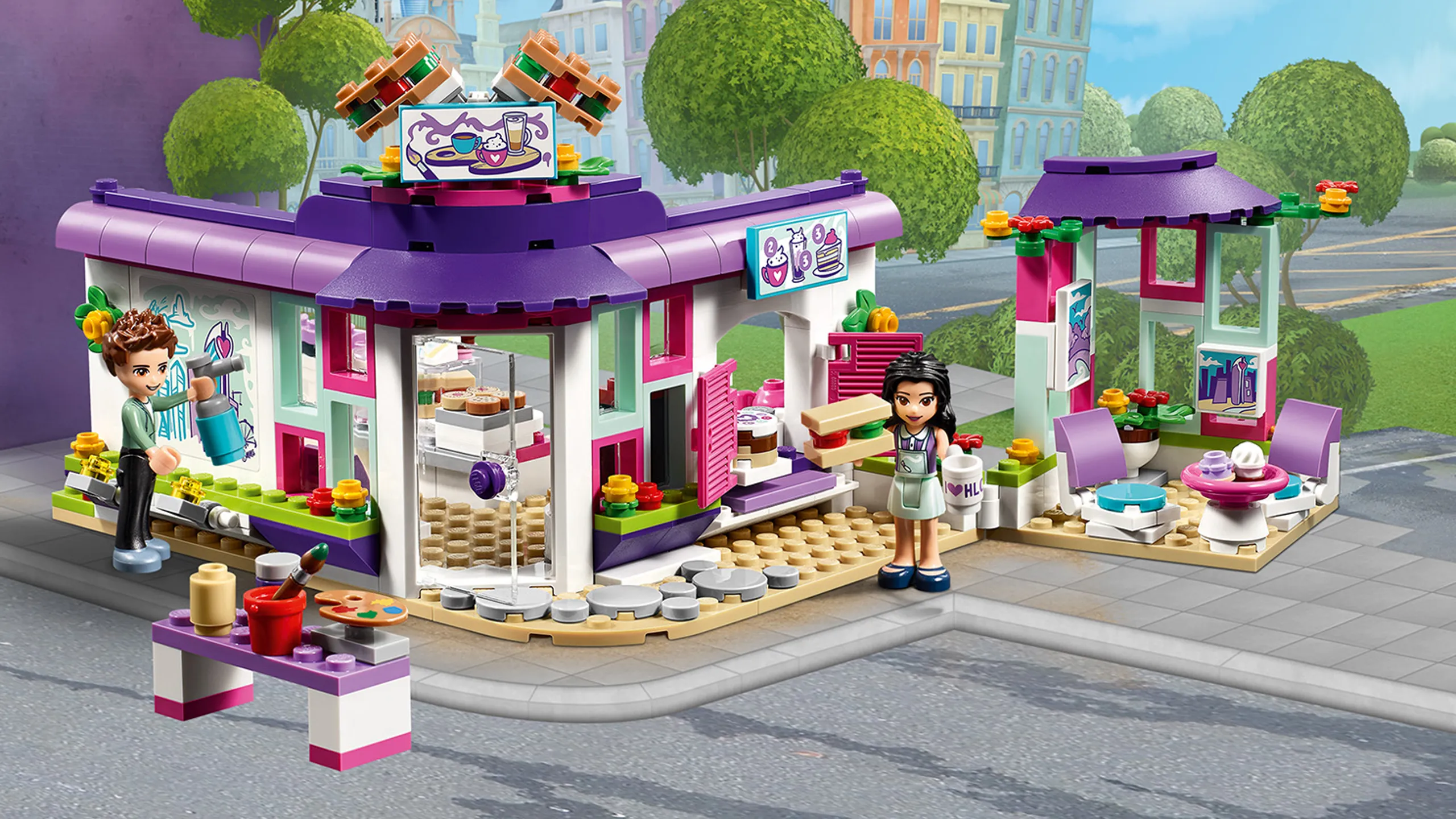LEGO Friends Emma's Art Café - 41336 - Emma loves stopping by the Art Café to bring out her creative side. Together with her friend Prankzy head inside to toast a delicious panini in the machine or brab a cup of coffee and some cake, pay at the cash register and eat inside or out.