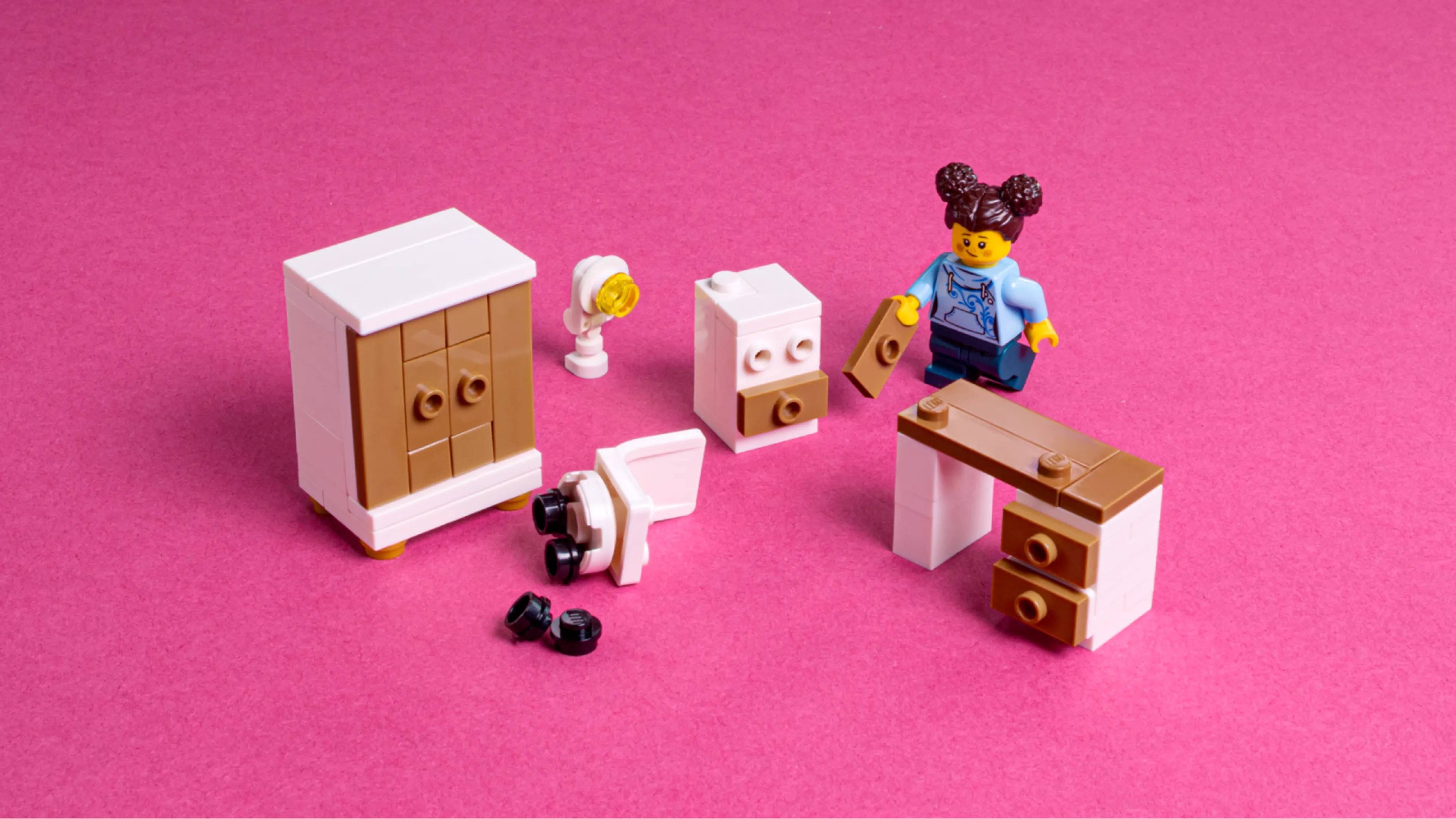 A minifigure building LEGO furniture