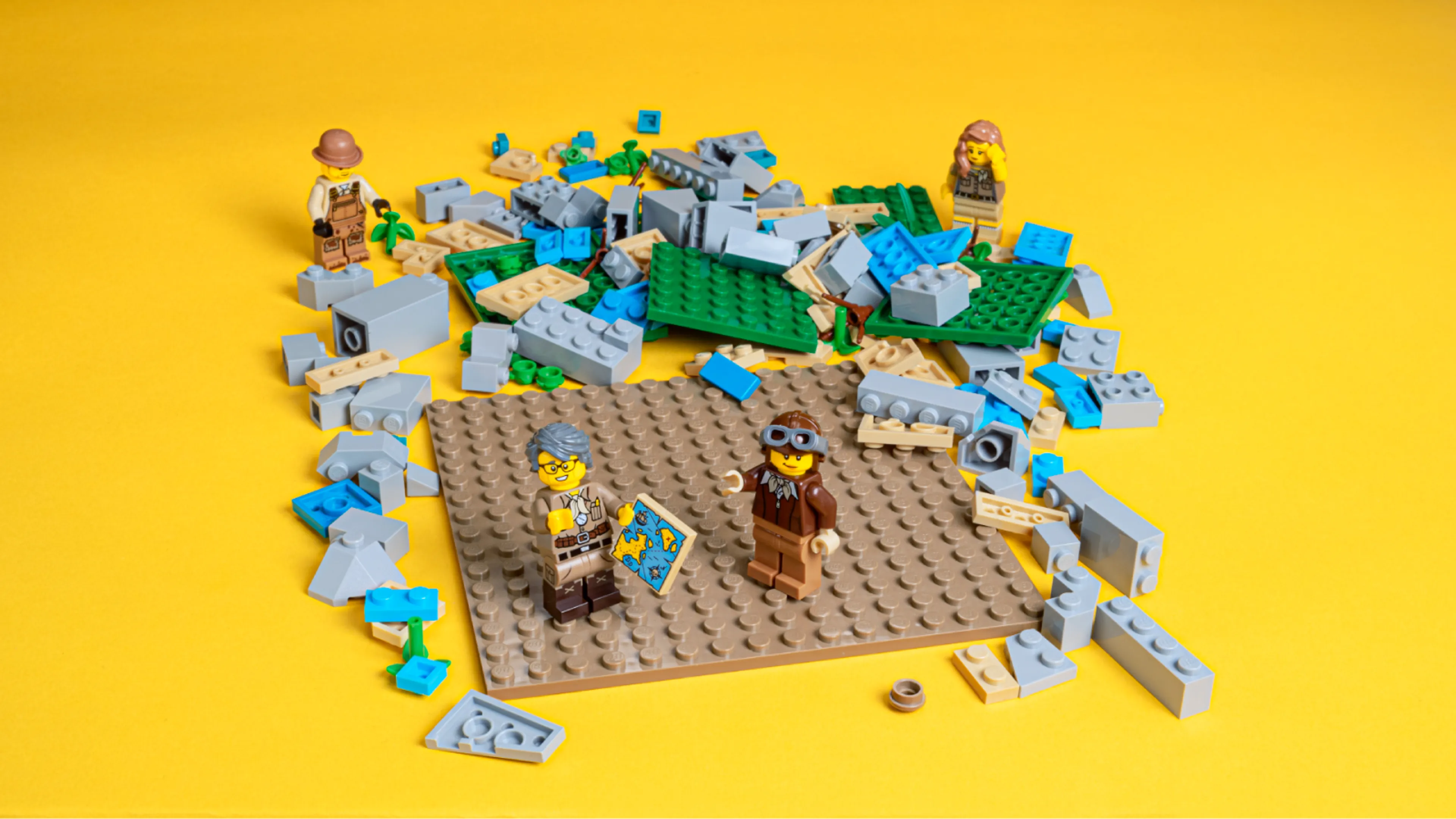 Minifigures building a LEGO map