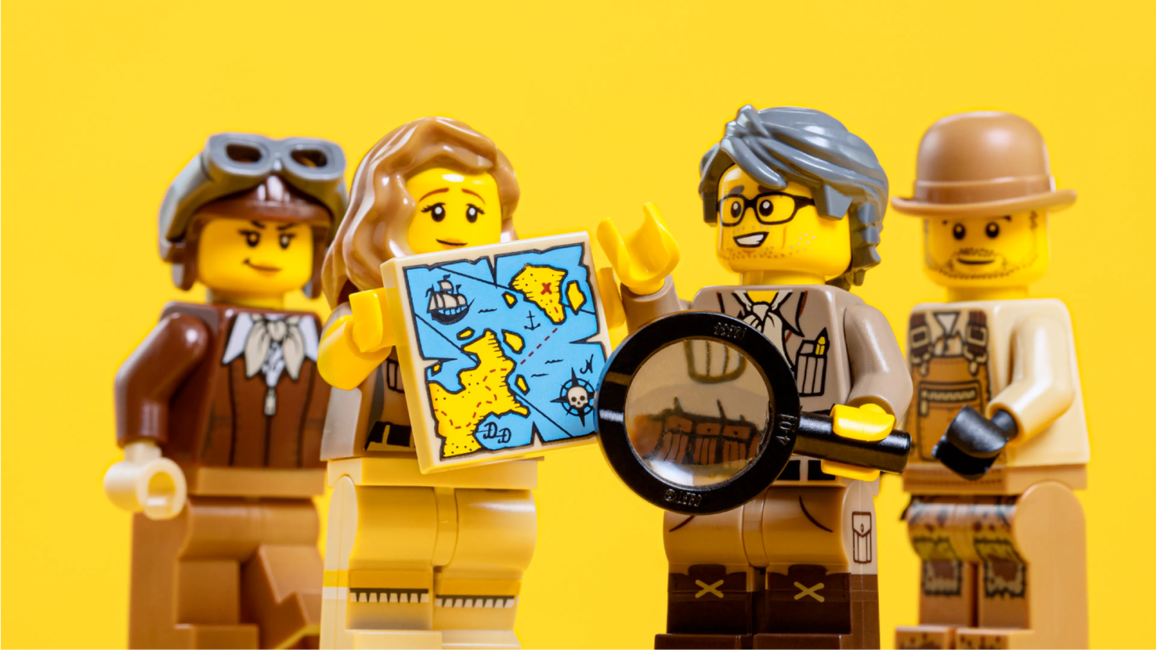Adventurer minifigures looking at a LEGO map