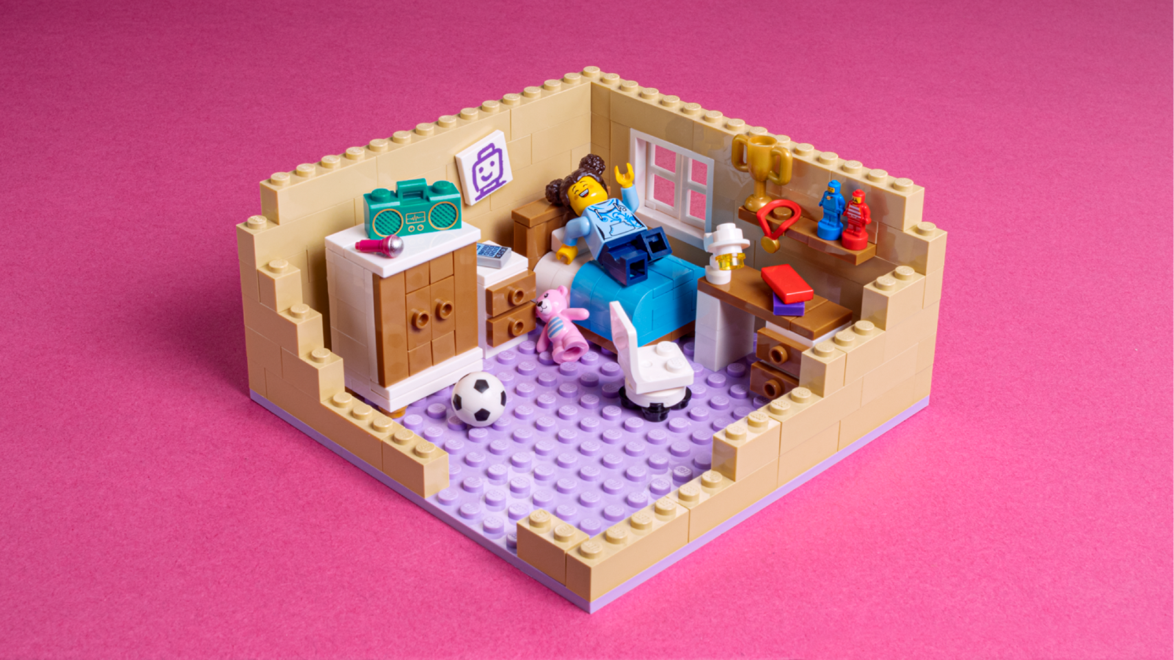 A minifigure lounging around in a LEGO bedroom