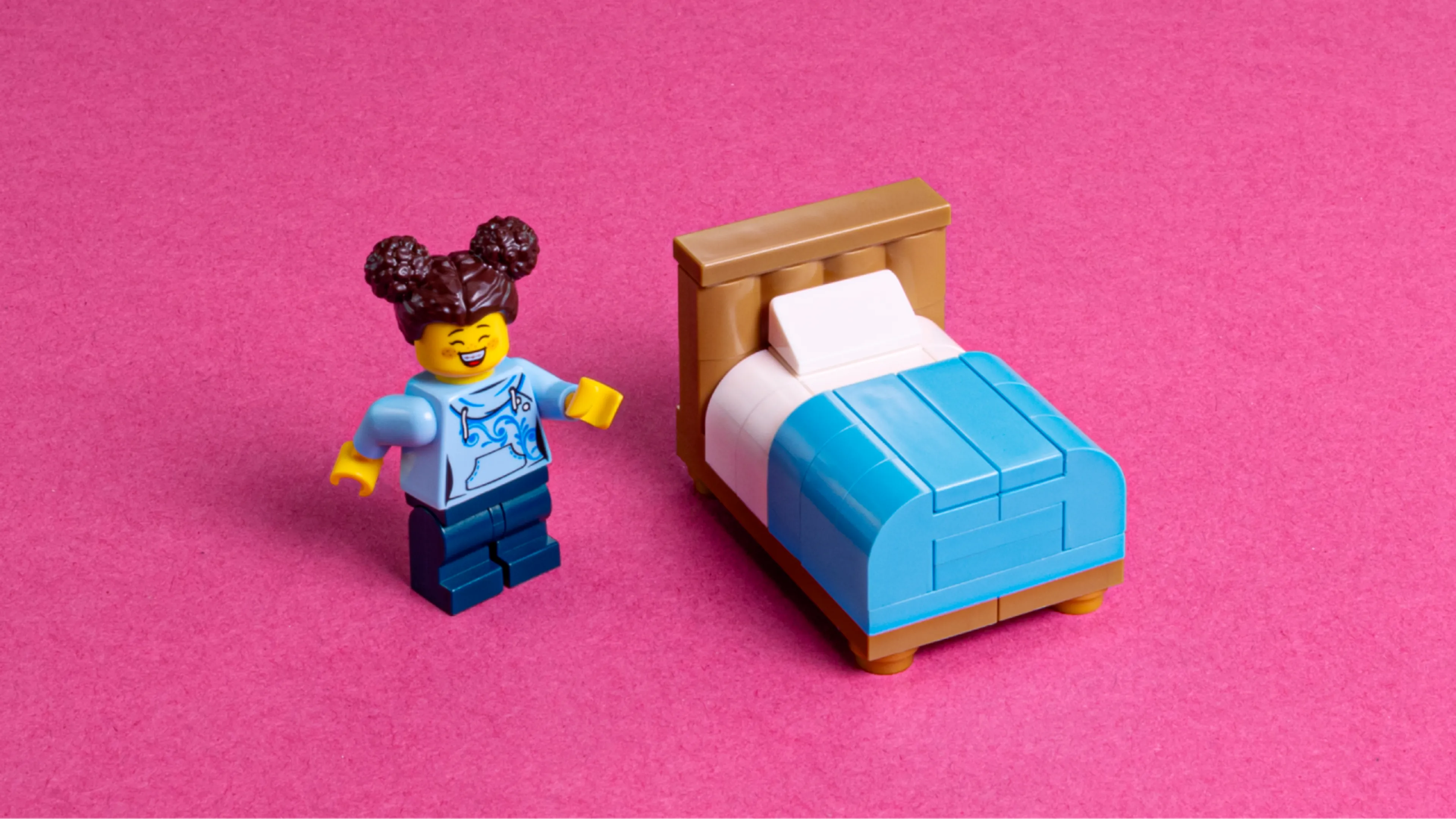 A minifigure and a LEGO bed