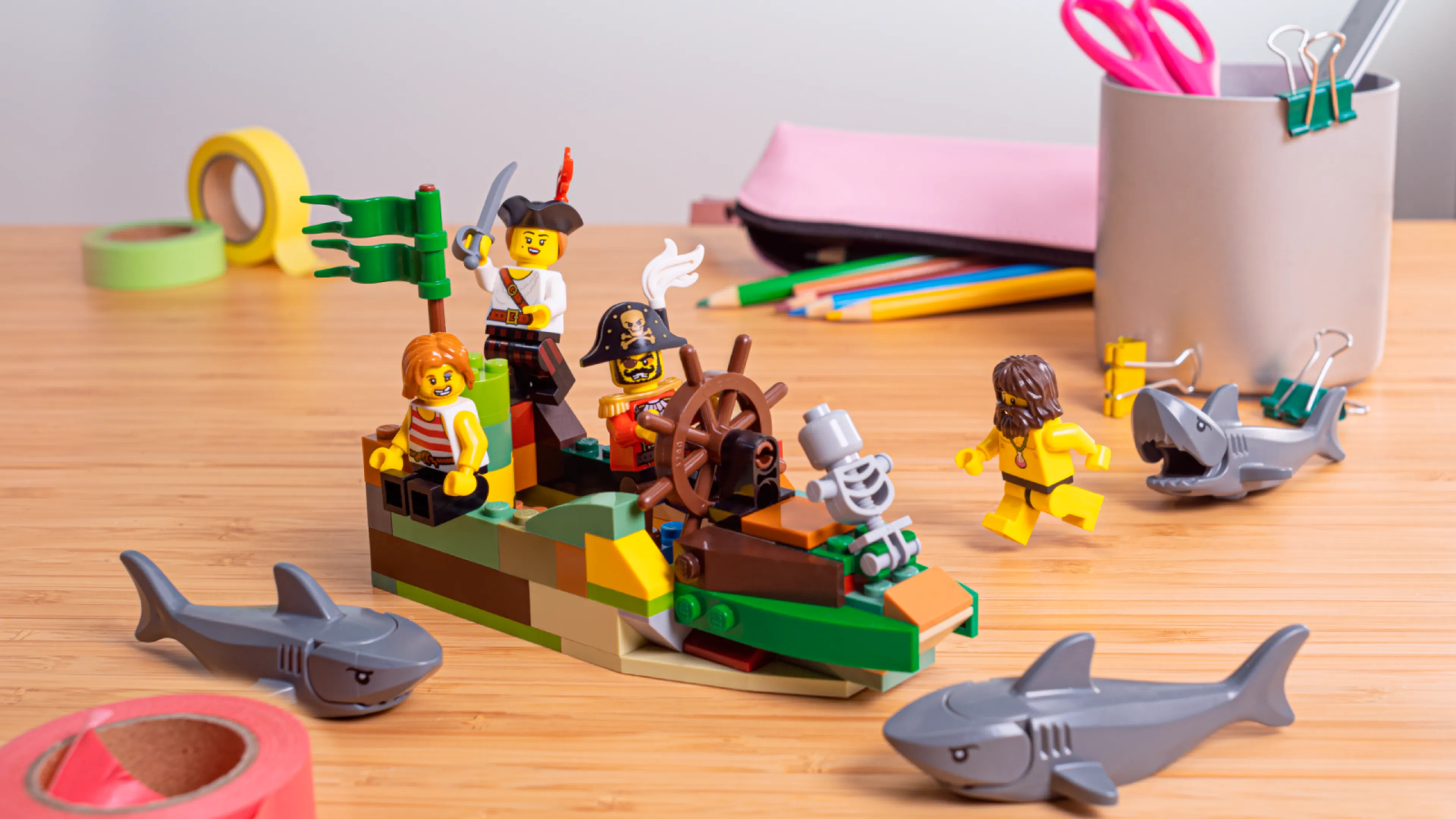 Minifigures on a ship, escaping from sharks