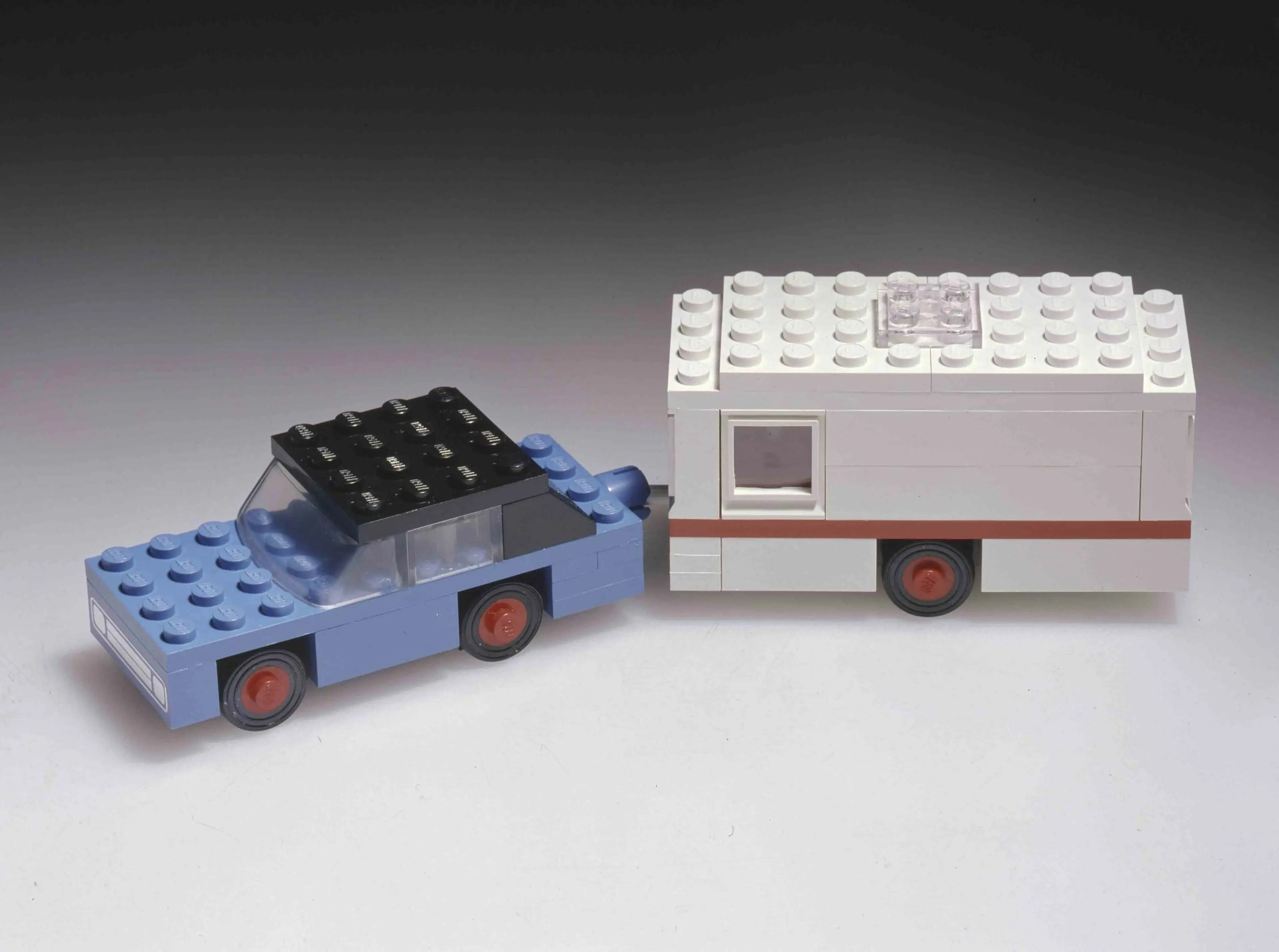 A blue LEGO car with a white caravan