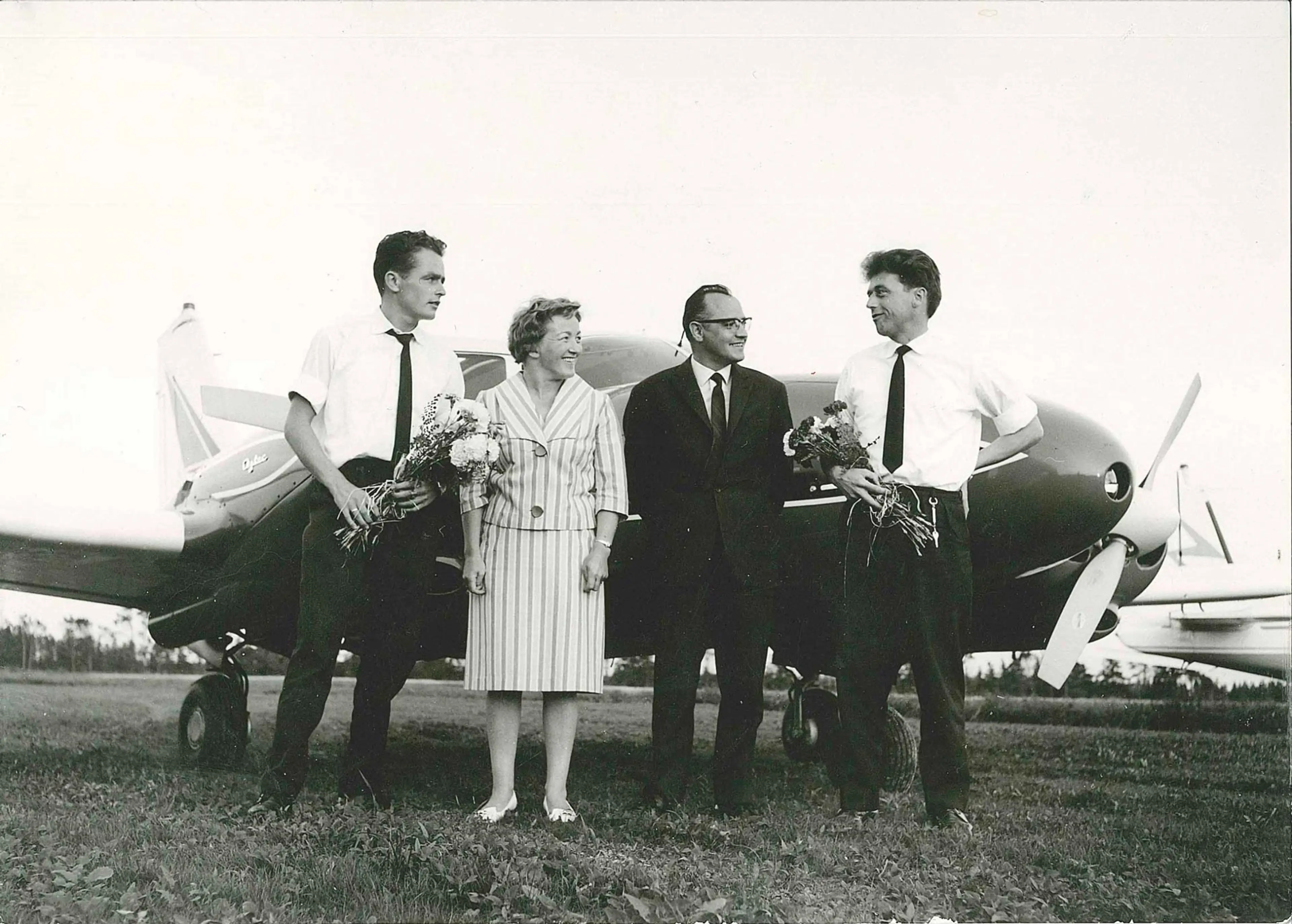 People standing in front of an airplane