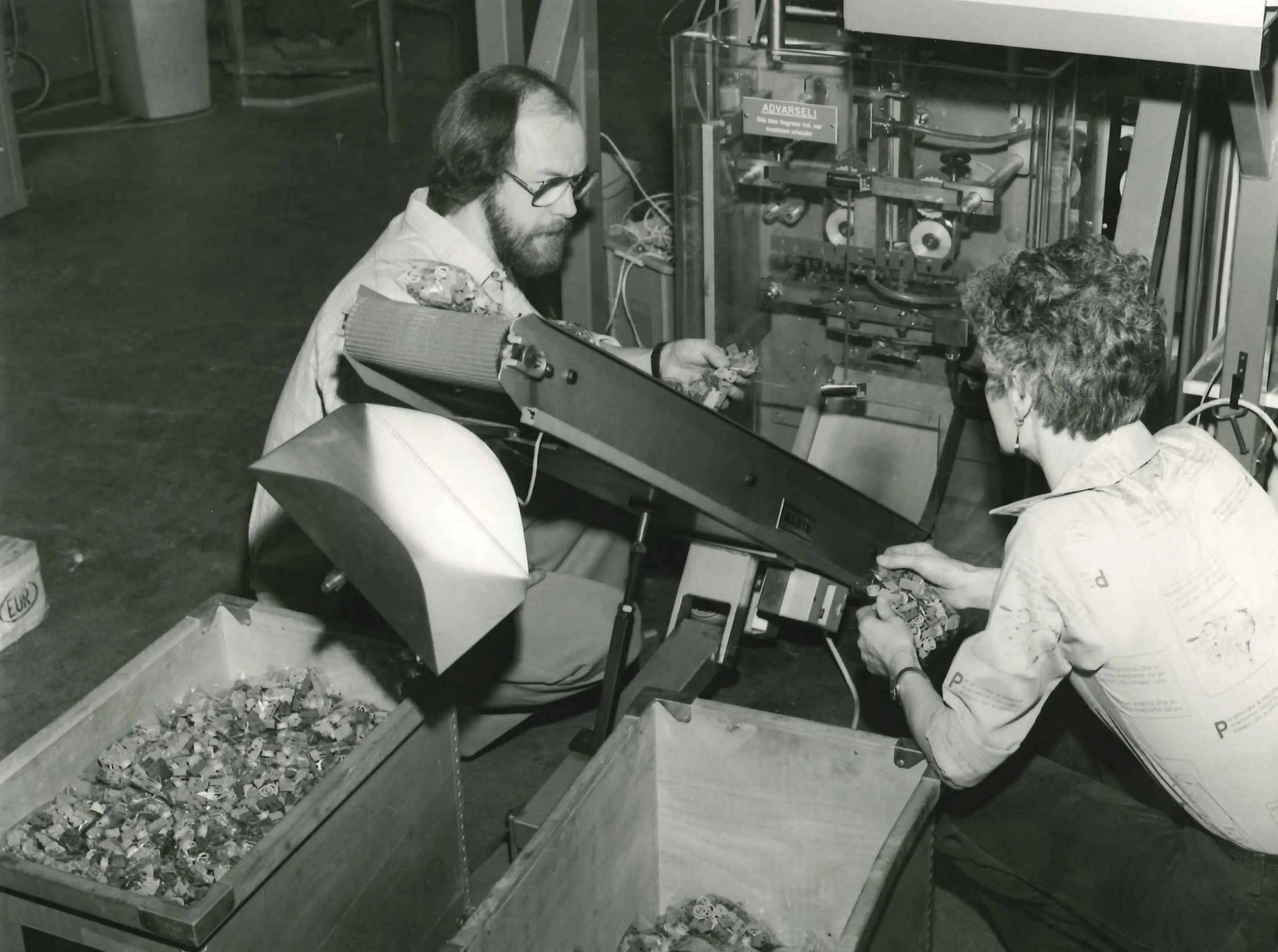 Two employees looking at a pre-pack machine