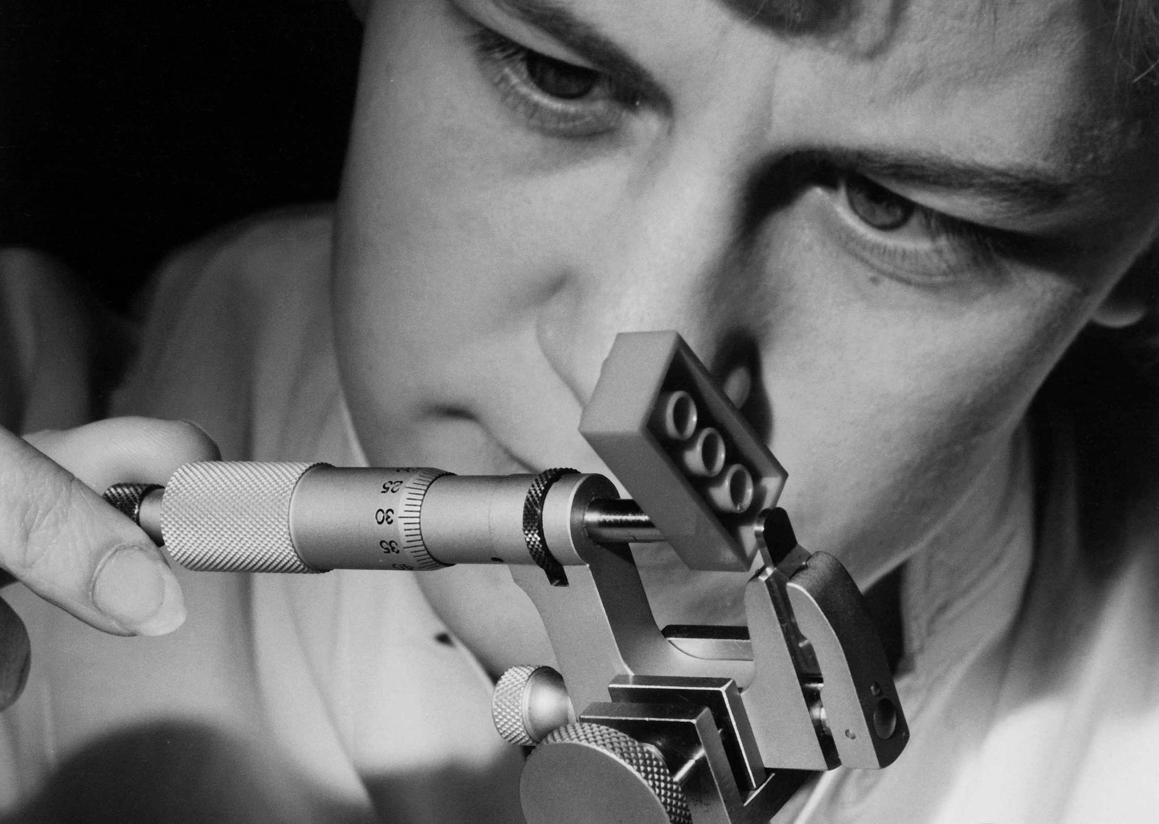 Employee measuring a LEGO® brick