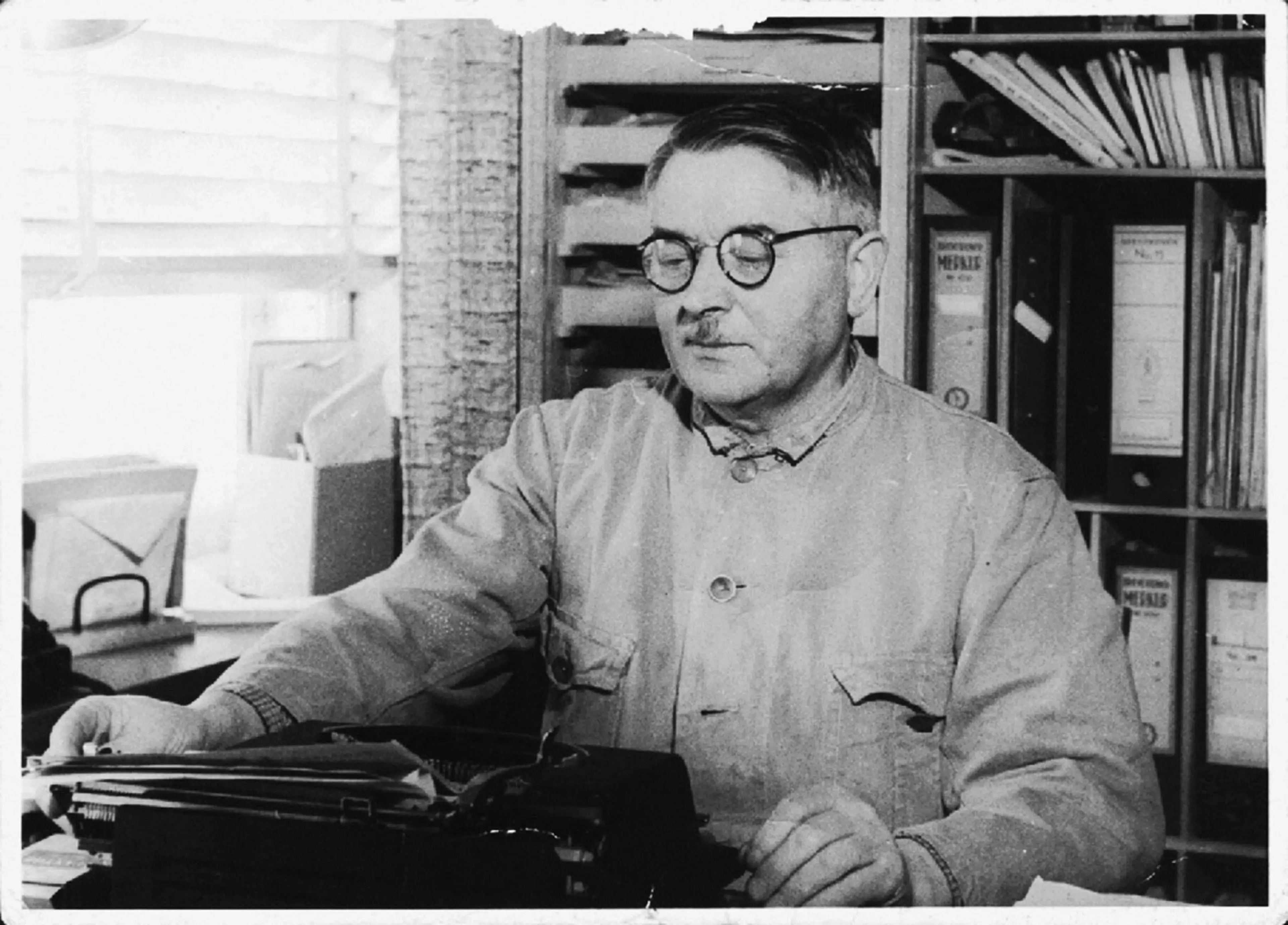 Ole Kirk sitting at a desk