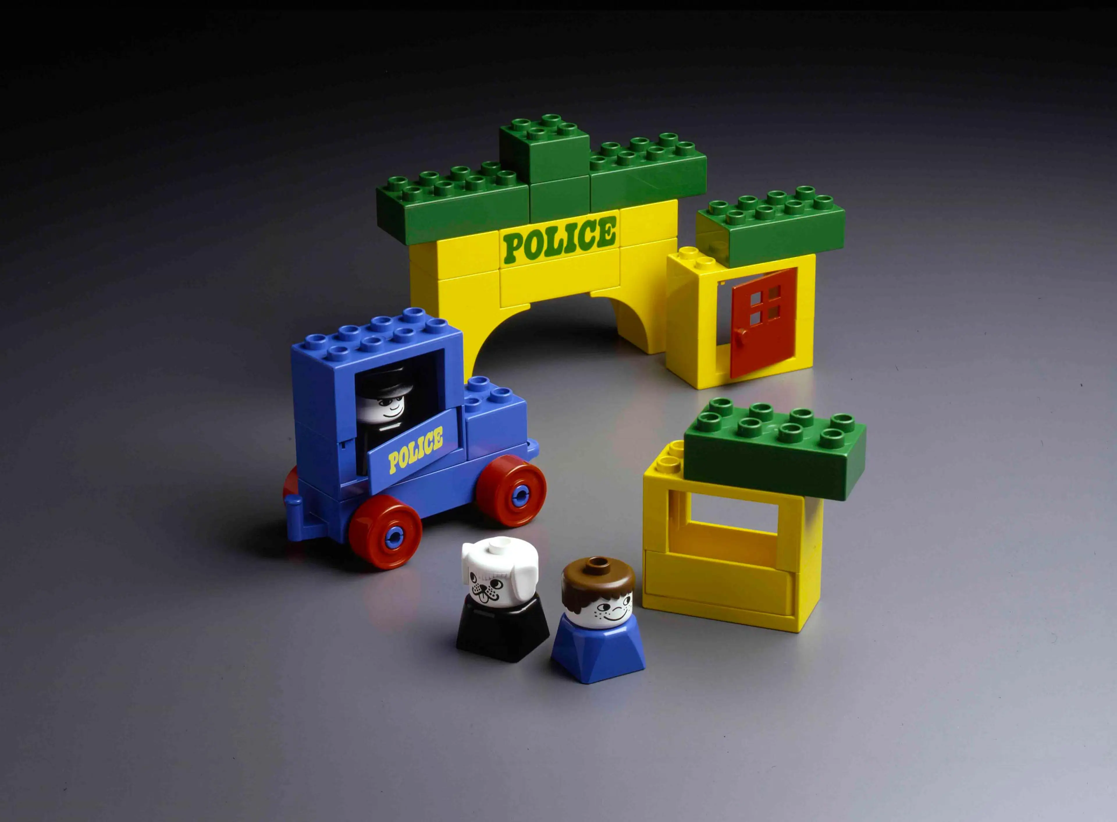 DUPLO set from 1977 containing DUPLO figures, a blue car and a yellow house