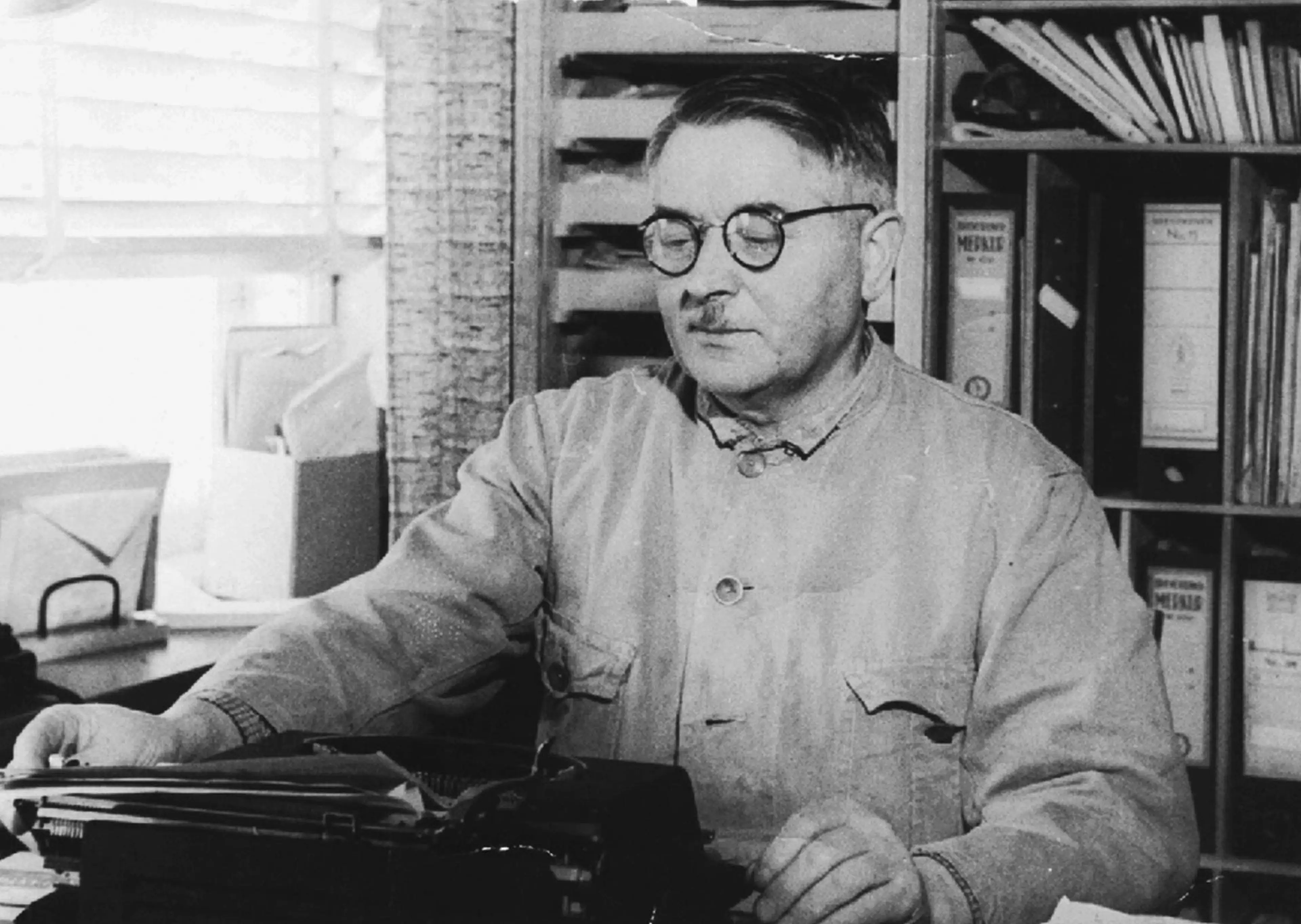 Ole Kirk typing a typewriter