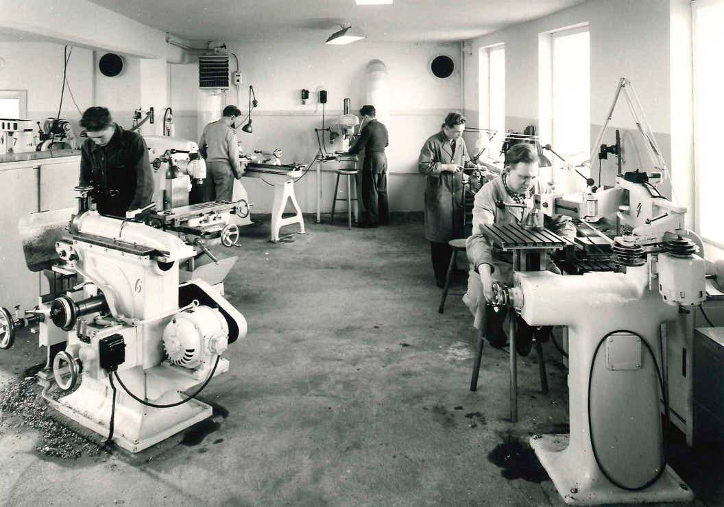 Employees operating machines in 1957