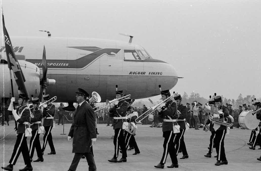 Marching band in front of an airplane