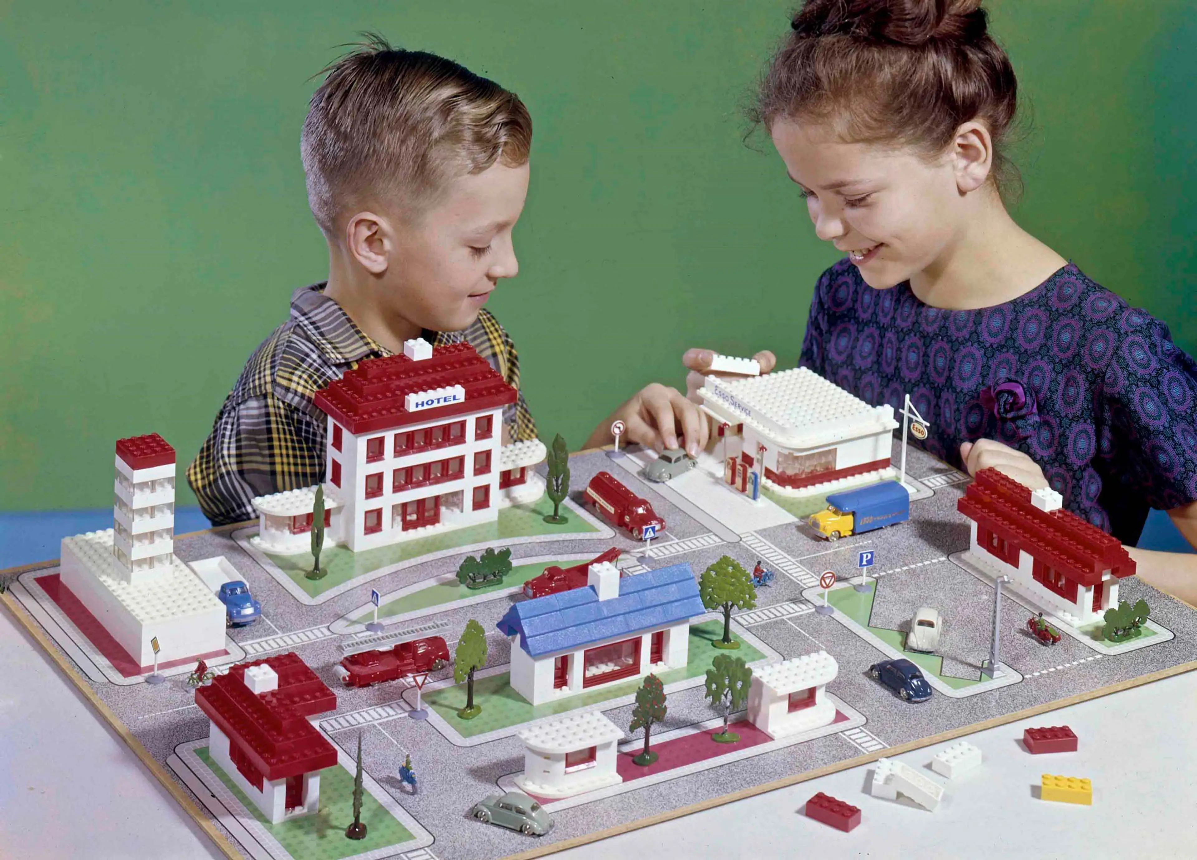 two children playing with a LEGO Town Plan