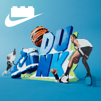 Fully built Nike Slam Dunk LEGO Set flanked by two cardboard cutout standees of basketball players with the LEGO and Nike logo lockup at the top.