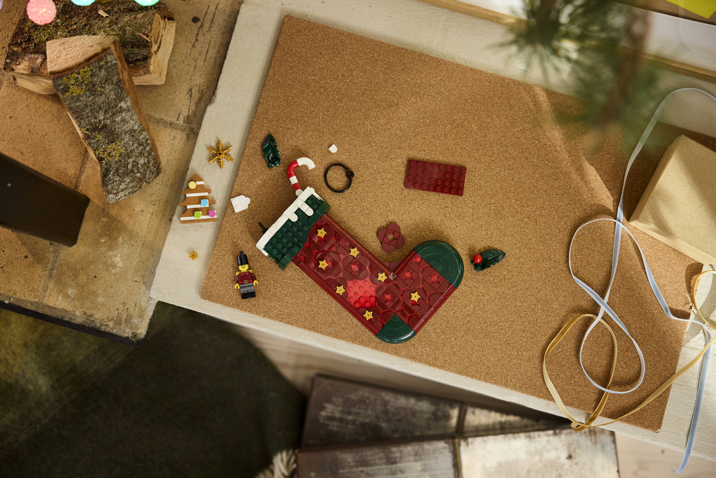LEGO 40958 Christmas Stocking lifestyle build shot with holly, gingerbread tree, and candy cane detail