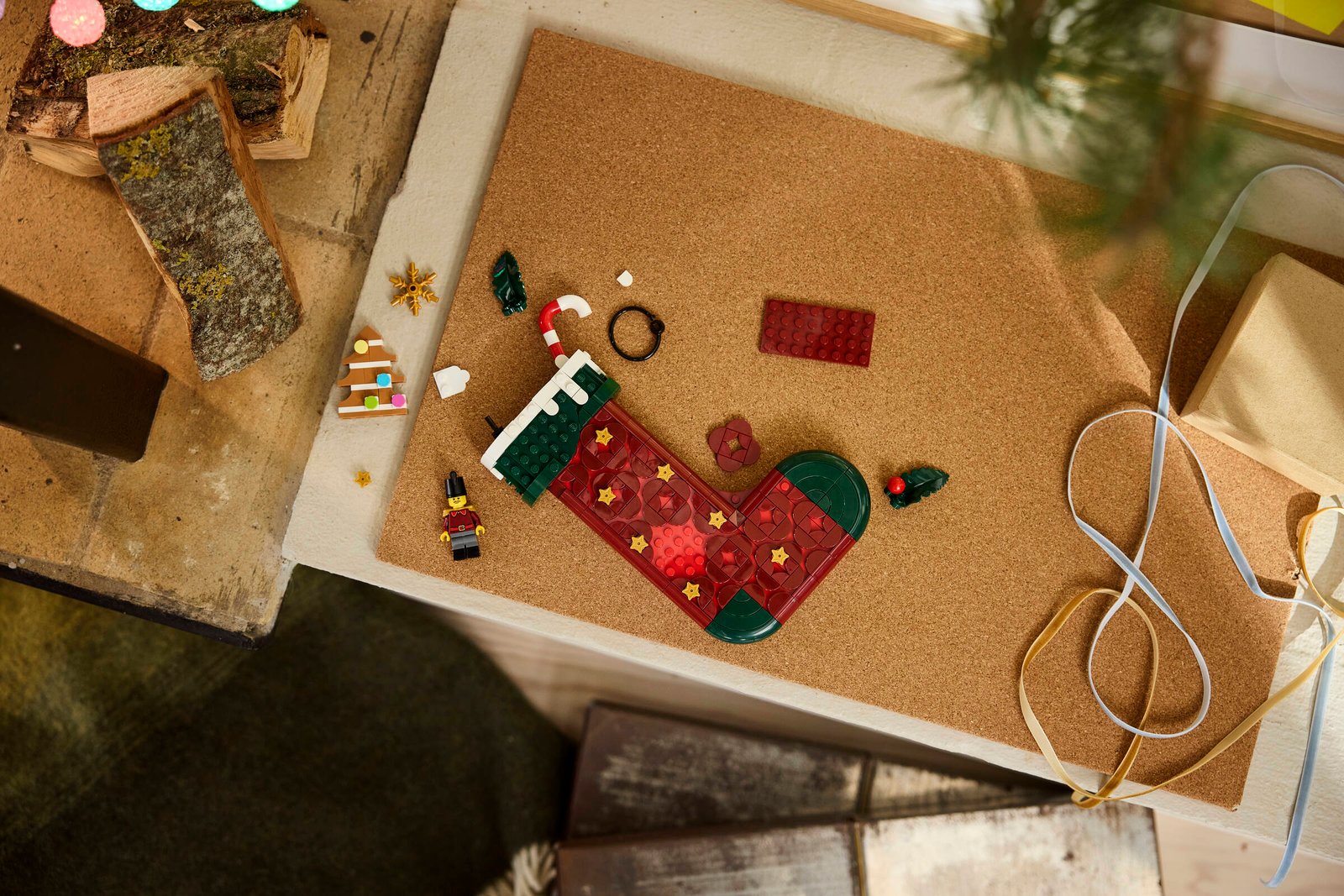 LEGO 40958 Christmas Stocking lifestyle build shot with holly, gingerbread tree, and candy cane detail