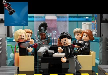 LEGO minifigures of Marvel Avengers characters sitting at a table