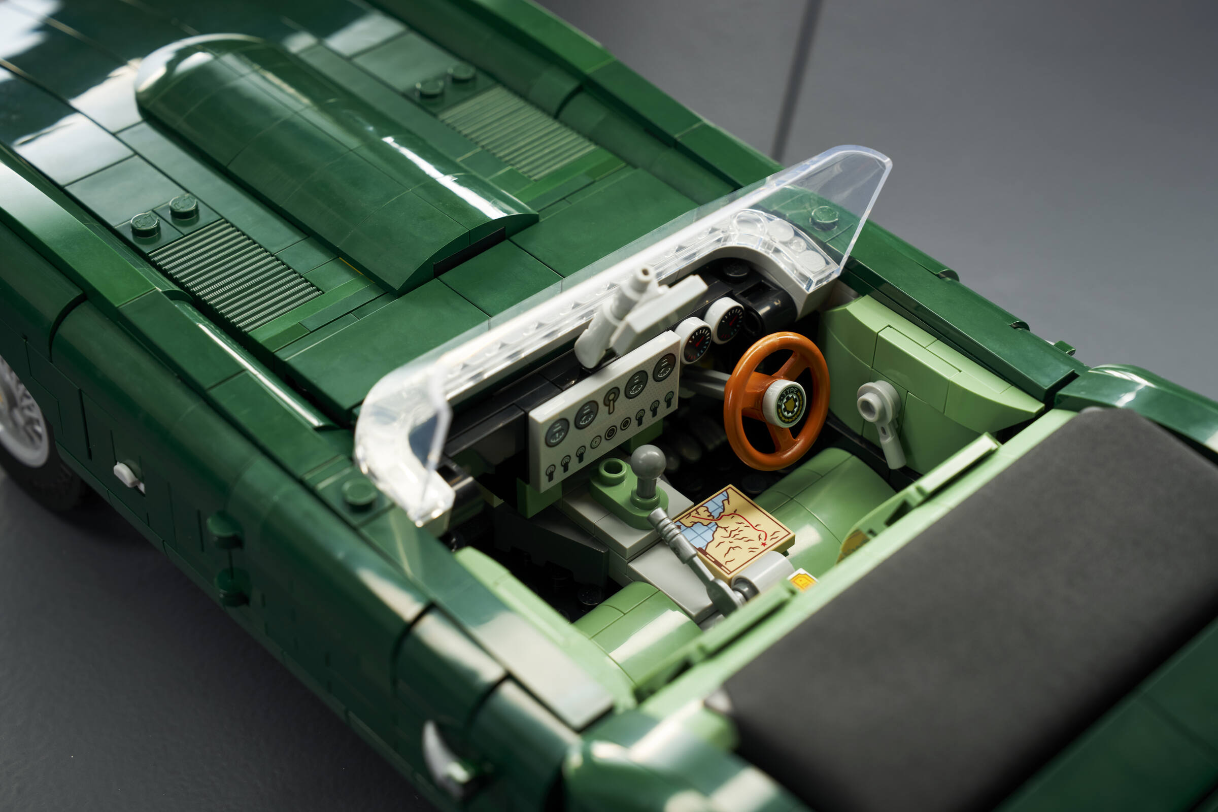 Close-up, aerial view of the cockpit and dashboard in a LEGO® Icons Jaguar E-Type set.