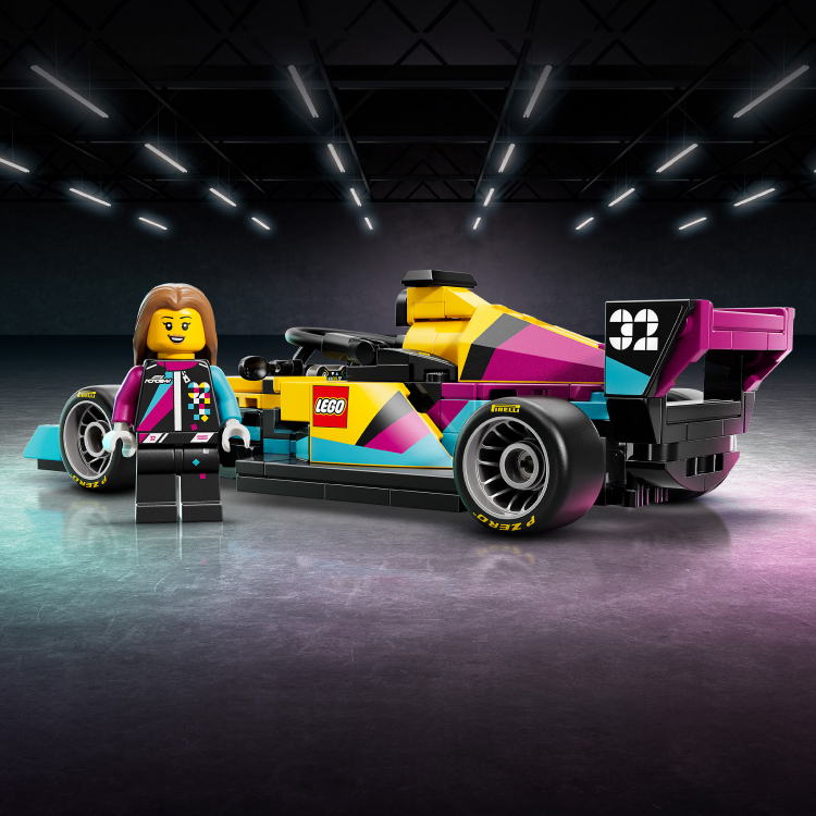 An image of a female driver minifigure standing next to the LEGO Speed Champions F1 ACADEMY LEGO Race Car.