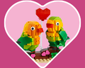 Heart-shaped background with the LEGO Valentines Lovebirds set inside.