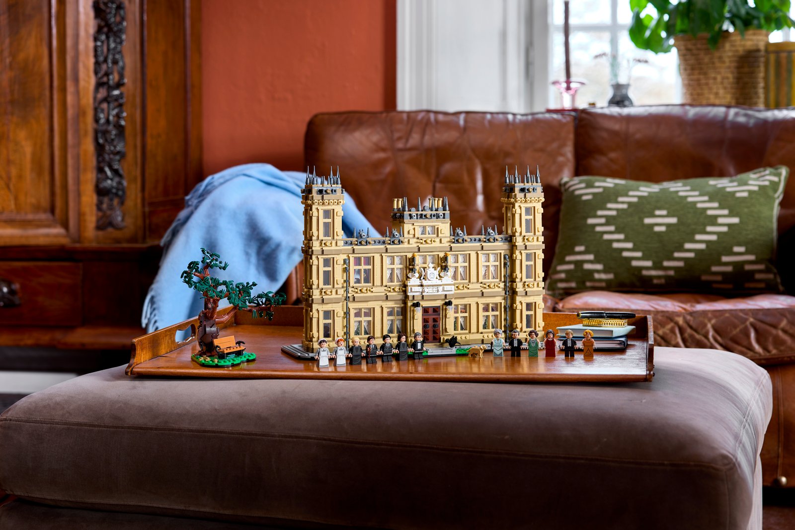LEGO Ideas Downton Abbey (21373) Highclere Castle model displayed in a real room setting, showing the full two-level scale of the build