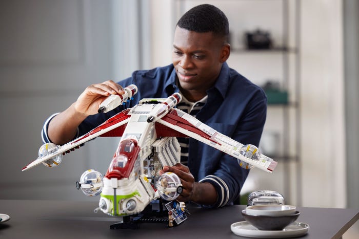 Man building the LEGO Republic Gunship from Star Wars