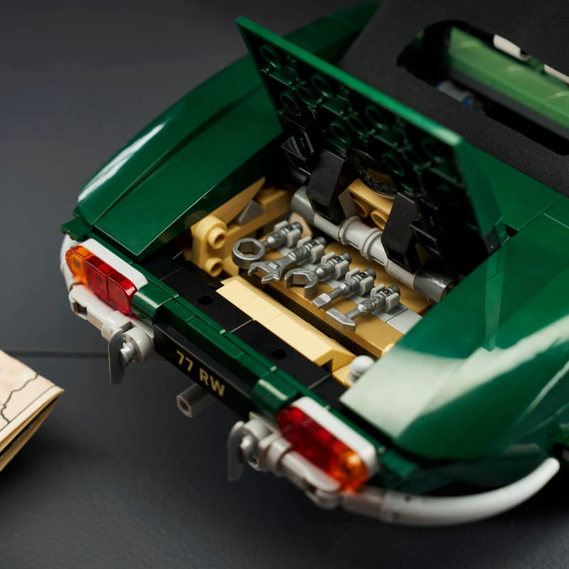 Close-up of the open trunk of a LEGO® Icons Jaguar E-Type set revealing the 5-piece tool kit inside.